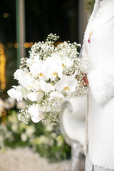 the bride holding a white orchid hand bouquet