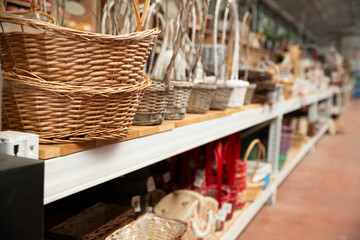 Decorative wicker baskets in store displayed on shelves in decor shop