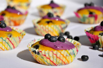 Blueberry muffins on a white table.