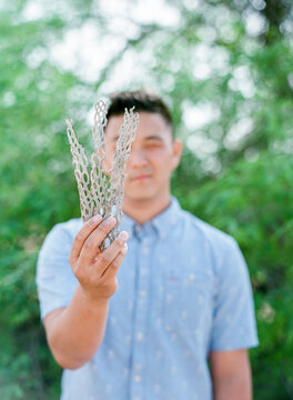 Young man holding cholla skeleton