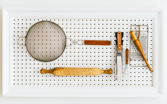 Chef's tools hanging on pegboard