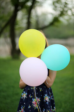 A Girl Outside With Balloons