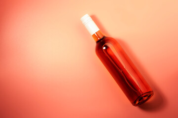Rose wine bottle on pink background. Rosado, rosato or blush wine tasting in wineshop, bar concept. Copy Space, top view
