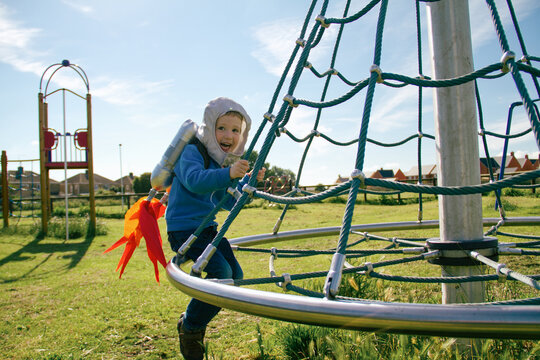 Boy in park wearing astronaut costume