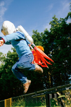 Boy pretends to lift off with rocket pack