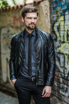 handsome man wearing leather jacket and tie