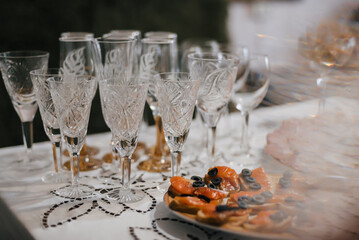 empty champagne wine glasses and red fish appetizer