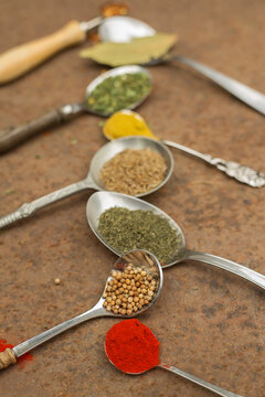 Colourful spices on the spoons