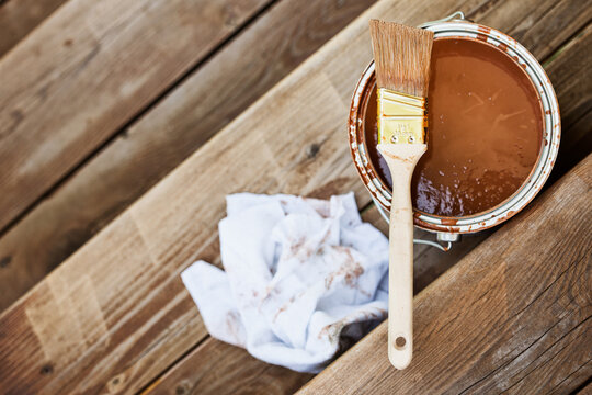 Staining: Brush And Can Of Stain Sit On Stairs