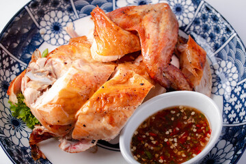 Close up. Baked chicken with dipping sauce.