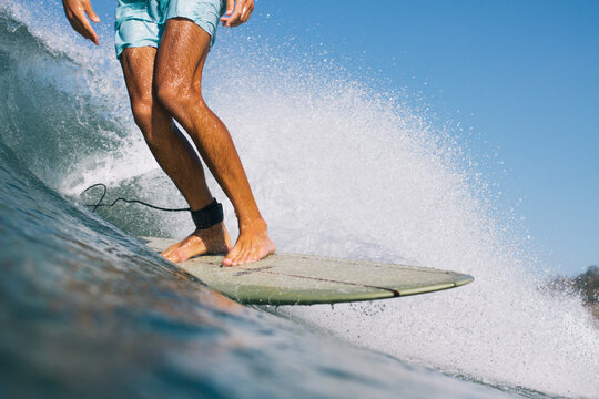 Surfer trims stylish down the line on his retro surfboard