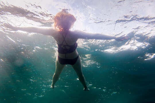 Woman Relaxing Floating In Water On Lake