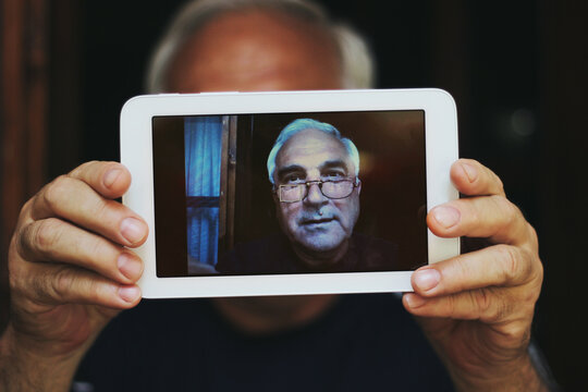 An Old Man Taking Selfie With A Digital Tablet