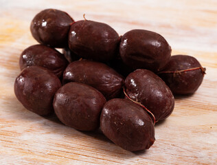 Spanish-style raw morcilla (blood sausage with rice) on wooden table..