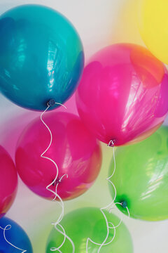 Floating colourful balloons seen from below