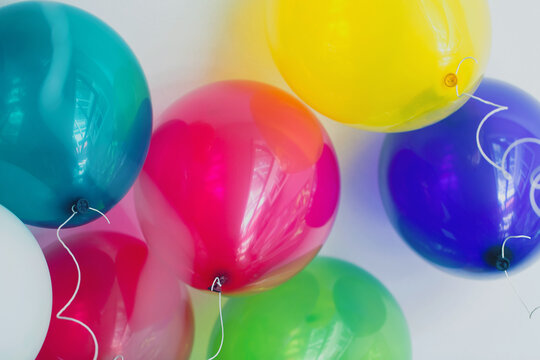 Horizontal shot of colorful bunch of floating balloons seen from below