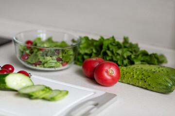 Healthy vegetarian dish on table, vegetable salad with fresh tomato, cucumber, lettuce. Diet menu.