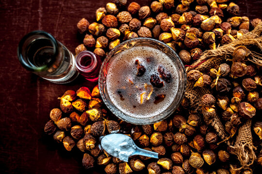 Close up shot of DIY shampoo made at home in a glass bowl consisting of some soapnut ell mixed ith essential oil, backing water, and some water.