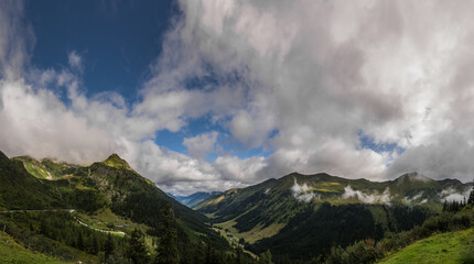 mountain landscape with streets and forest with clouds panorama