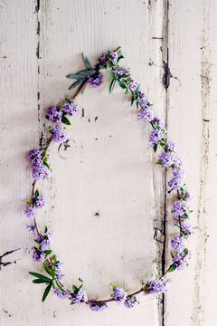 A wreath made from Buddleia flowers hanging on an old door.