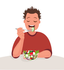 Man is eating a salad. Vegetarian. The concept of proper nutrition and healthy lifestyle.