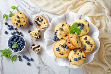 Blueberry muffins on a white cake stand, close-up
