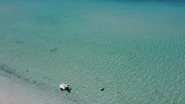 Man sells ice cream into the sea, Tecolote beach, La Paz, Baja California Sur, Mexico