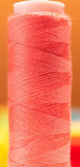 Close up looking of a pink thread reel.