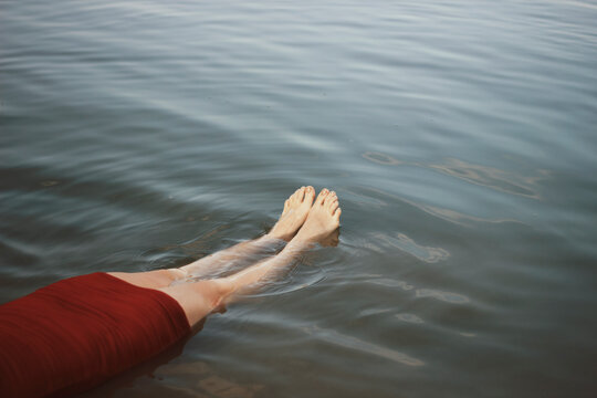 Womans feet floating in water