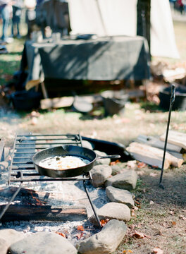 Vintage style fire pit with cast iron pots, pans and utensils