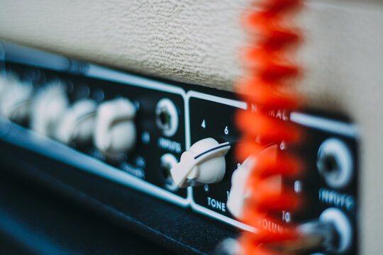 Vacuum Tube Guitar Amplifier Front Controls with a Retro Coiled Orange Cord