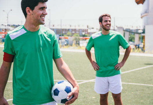 Soccer team players with soccer ball on a soccer field during a soccer match