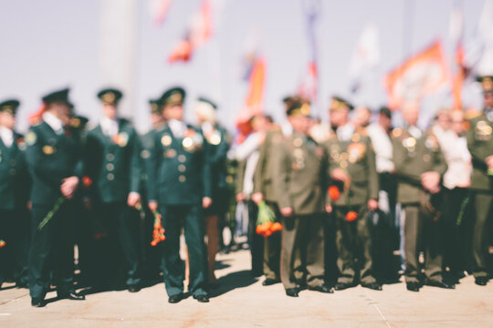 Officers and veterans stand on at Victory Day celebrations