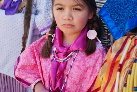 A young Native American girl in traditional clothing