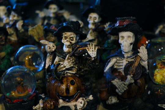 Halloween decoration. Scary figurines of the dead on the shelf.