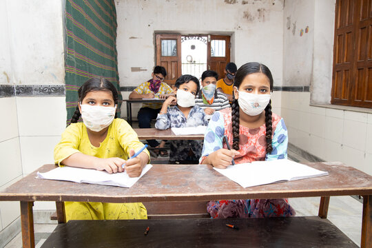 Indian Students Studying In Classroom Wearing Mask And Social Distancing, school reopen during covid19 pandemic