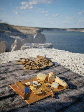 Cheese plate picnic over looking water.