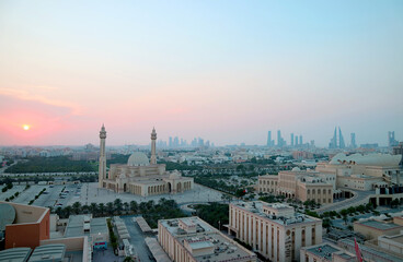 Panoramic Aerial View of Manama with the Al Fateh Grand Mosque and Group of Iconic Landmarks against Pastel Color Sunset Sky