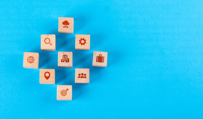 Conceptual of medical center with wooden blocks with icons on blue background flat lay. copy space for text horizontal image