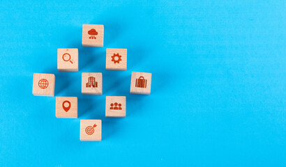 Conceptual of medical center with wooden blocks with icons on blue background flat lay. copy space for text horizontal image