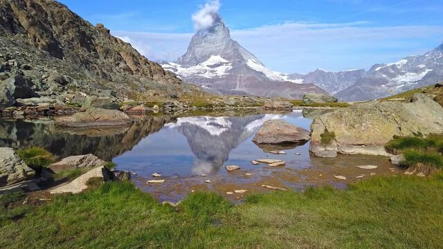 Reflection of Mount Matterhorn on Riffelsee Lake in Zermatt, mountain resort in Swiss Alps, Canton of Valais, Switzerland. Riffelsee is located on Riffelseeweg trail on Gornergrat Bahn cog railway.