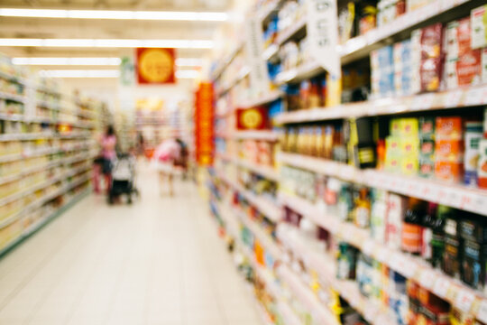 Supermarket shelves and corridor - blurred image