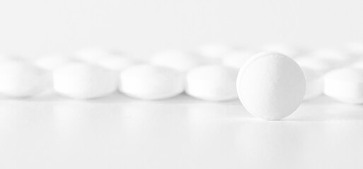 Image of white pills on white background. Medicine concept,