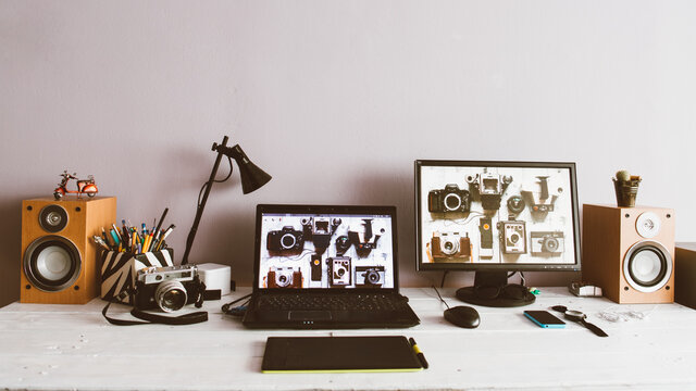 Creative workspace with laptop and monitor