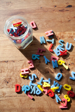 vintage children's letters and numbers arranged on a wooden table