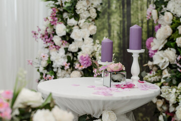 Wedding ceremony Photo booth zone decorated with roses and candle composition.