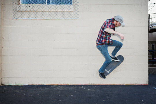 Skateboarder doing a wall ride