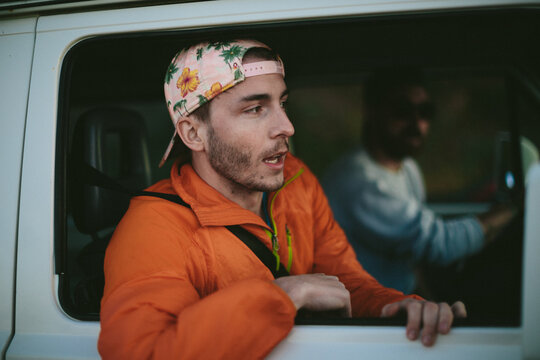 Young man asks for directions out the window of his van
