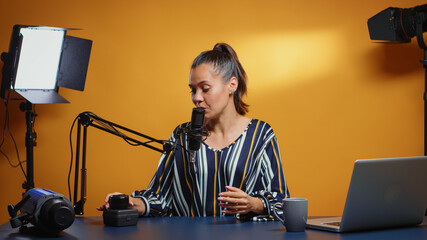 Influencer talking about new camera lens in her weekly podcast review episodes. Content creator new...