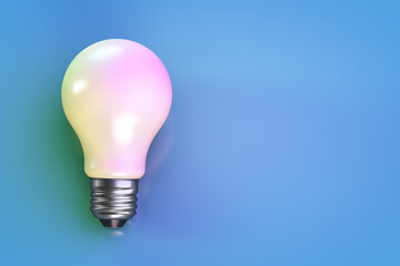 Energy saving light bulb on a blue surface. Copy space.